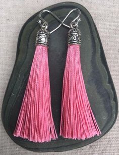 Chic pink tassel earrings!  They would add a pop of color to any outfit for any occasion.  Dress them up or down.  They are timeless and versatile.  They are lightweight, fun and unique!The tassels measure 2 1/8” long by 1/4” wide.  They hang from simple silver ear wire hooks.  Overall drop length is about 2 1/4”.  Metal is allergy free plated silver.These are my latest creation!  I have them available in many colors!  Find them all under the category tassel earrings in my shop.Thanks for stoppi Pink Tassel Earrings As Gift, Pink Tassel Jewelry As A Gift, Pink Earrings With Latkans For A Gift, Pink Latkans Earrings For Gift, Pink Dangle Tassel Earrings With Fringe, Pink Fringe Tassel Dangle Earrings, Pink Dangle Tassel Earrings For Gifts, Pink Tassel Earrings For Gift, Pink Tassel Earrings With Latkans