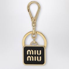 a black and gold keychain with the word hebrew written in white on it