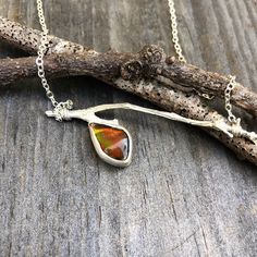 The Centerpiece Of This Bar Necklace Is A Freeform Ammolite, Also Known As Mother Nature's Stained Glass Gemstone. Ammolite Is Cut From The Fossilized Shells Of Prehistoric Sea Creatures Called Ammonites And Is Found In One Very Specific Part Of Canada. This Iridescent Gemstone Come In Any Color Of The Rainbow, But Most Are Green Or Red, While Blue And Violet Are Rare. The Stained Glass Look Of Ammolite Comes From The Natural Surface Fractures. Prehistoric Sea Creatures, Iridescent Gemstone, Stained Glass Necklace, Minimalist Bar, Soldering Jewelry, Soldering, Bar Necklace, Sea Creatures, The Rainbow