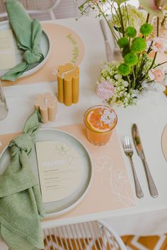 the table is set with plates, napkins and silverware