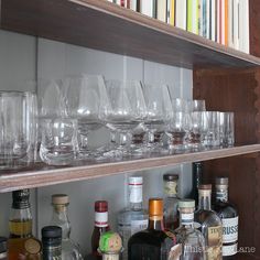 many glasses are lined up on the shelf