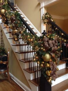 a staircase decorated with christmas garland and lights