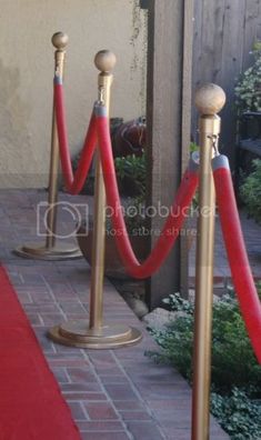 some red ropes and poles on the side of a building with words diy rope stanchions