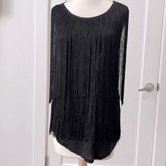 Black T-Shirt Material Sleeveless Top With Layers Of Long Black Fringe. Very Swingy If You Need That Kind Of Energy In Your Life! New With Tags. Chic Fringe Tops For Party, Chic Fringe Top For Evening, Fitted Sleeveless Tank Top With Fringe, Fitted Sleeveless Fringe Tank Top, Black Sleeveless Tank Top For Date Night, Sleeveless Fringe Tank Top For Party, Black Sleeveless Tank Top For Party, Sleeveless Party Tank Top With Fringe, Party Fringe Sleeveless Tank Top