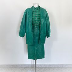 Vintage 80s green soft leather skirt suit. The suit consists of a green leather skirt and jacket. The pencil skirt has a high waist, two front pockets and a front placket with zip and button. The blazer has a single button placket and an oversized fit. Fabric: 100% leather Size: Italian 42, which corresponds to a size S/M approximately. You can see it on a size S mannequin, but I recommend checking the exact measurements also because the suit has an oversized fit BLAZER MEASUREMENTS Shoulders: 5 Green Leather Skirt, Etsy Vintage Clothes, Womens Suit, Etsy Clothes, Leather Suit, 1990's Fashion, Fitted Blazer, Suit Set, Skirt Suit