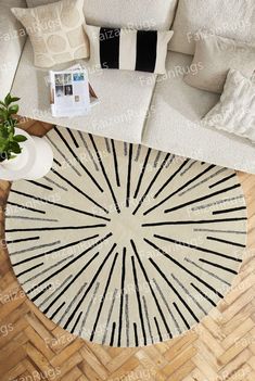 an aerial view of a living room with white couches and black and white pillows