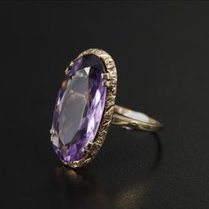 Style: Victorian Materials: 9K Gold Ring Size: 6.75 Hallmarks: 9 with Pictorial Markings Total Weight: 2.10 dwt Primary Stone Type: Amethyst Primary Stone Shape: Oval Faceted Primary Stone Count: 1 Primary Stone Dimensions: 20.00 mm x 10.00 mm Classic Yellow Gold Amethyst Ring With Diamond Cut, Formal Gold Amethyst Ring With Diamond Cut, Classic 14k Gold Amethyst Ring For Formal Occasions, Classic Gold Amethyst Ring, Classic Hallmarked Amethyst Ring For Formal Occasions, Formal Amethyst Ring With Diamond Cut, Elegant Stamped 14k Yellow Gold Amethyst Ring, Classic Formal Hallmarked Amethyst Ring, Classic Amethyst Ring For Formal Occasions