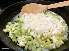 onions and celery being cooked in a skillet