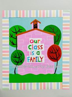 a pink house with trees and the words our class is a family painted on it