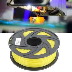 a spool of yellow pla next to an image of a skateboarder