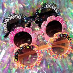 two pairs of sunglasses that say happy birthday and are decorated with beaded letters on them