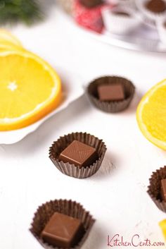 orange slices and chocolates on a white table