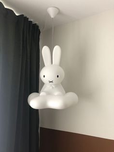 a white rabbit lamp hanging from the ceiling