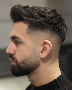 Man wearing a thick black faux hawk hairstyle with a high skin fadeThis hairstyle was included in the articleThe Faux Hawk HaircutWhat It IsThe Best Fade Versions For 2023on MensFlair.com Faded Hair And Beard Style, Haircut For Groom, Barber Beard Style, Beard Hairstyles For Men, Hảir Style For Boys, Beard Fade Men, Men Hairstyles With Beard, Good Boy Haircuts, Best Hair Styles Boys