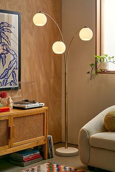 a living room scene with focus on the floor lamp and couch in front of it