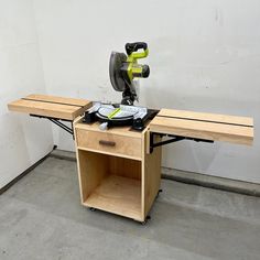 a table saw sits on top of a workbench in a room with white walls