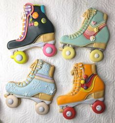 decorated cookies in the shape of roller skates on a white surface with colorful icing