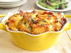 a yellow casserole dish sitting on top of a wooden table