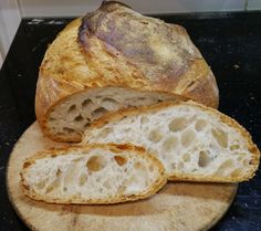 a loaf of bread sitting on top of a wooden cutting board