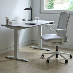 an office chair sitting next to a white desk