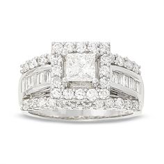 a white gold ring with two princess cut diamonds on the sides and baguetts