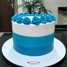 a blue and white cake sitting on top of a table