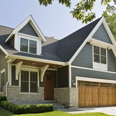 a large house with two garages on the front and one above it's door