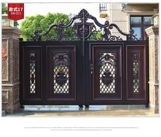 an ornate iron gate with decorative glass panels