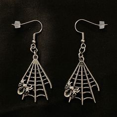 "This is a pair of fun dangling earrings featuring silver spider webs with tiny little spiders on them. They are hung on silver ear wires. Just over 2\" long, the dangle is 1 1/2\" and 1\" wide. Make sure to check out my shop for more hair pins, jewelry, accessories, and all sorts of fun stuff! Spider Earrings, Silver Spider, Goth Earrings, Spider Web, Spider Jewelry, Creepy Spiders, Halloween Spiders, Spiderweb, Silver Spider Web" Spooky Silver Dangle Earrings, Gothic Hypoallergenic Halloween Earrings, Silver Punk Earrings For Halloween, Halloween Themed Silver Earrings, Silver Themed Earrings For Halloween, Themed Silver Earrings For Halloween, Witchy Silver Earrings For Halloween, Silver Spooky Halloween Earrings, Wydowna Spider