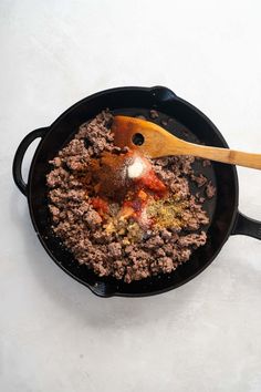 a skillet filled with ground beef and spices