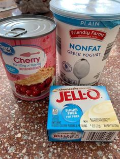 yogurt and jelly are on the counter next to each other, including one in a can