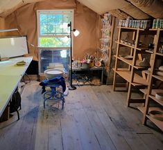 a room with wooden flooring and walls covered in canvas