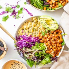 two bowls filled with different types of food next to cups of coffee and spoons