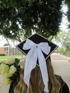 a woman wearing a black and white graduation cap