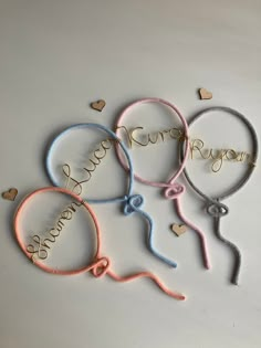 four different colored hair ties with the word love on them