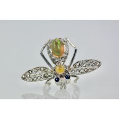 This is part of Chairish’s Fine Jewelry assortment.  14K Butterfly with Silver Articulated Wings Opal Body  This butterfly is unique as they started out as pins and I turned them into rings. The wings are set with Diamonds over silver and they move with your hand as they are flying around. The body is 14K gold and two Jelly Opals form the body and head. The eyes are Sapphire cabochons. They weigh 9.0 grams and measure 1 3/4" open wings, length is 1 1/4" and the depth is 6.01 average ring size 6. Antique Multi-stone Brooches For Formal Occasions, Silver Fine Jewelry Brooches For Wedding, Antique Multi-stone Ceremonial Jewelry, Yellow Gold Multi-stone Brooches As Gift, Collectible Round Gemstone Brooch, Fine Jewelry Brooch For Collectors, Collectible Round Gemstone Brooches, Fine Jewelry Multi-stone Brooches As Gift, Collectible Fine Jewelry Brooch