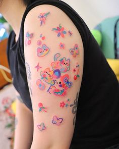 a woman with colorful tattoos on her arm