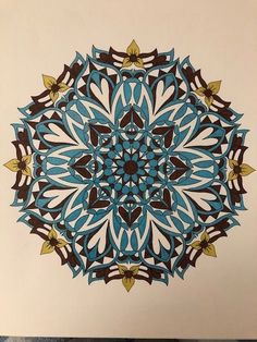 a blue and brown circular design on white paper