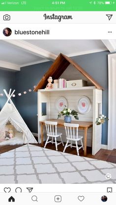 a room with blue walls, white chairs and a desk in the corner next to a bed