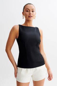 Timeless with a twistThe ANGELA Sleeveless Suiting Top is a sophisticated and versatile piece designed for a polished look. Featuring a boat neckline and contour seam lines, this top creates a flattering and elegant silhouette. The longline cut adds a modern touch, while the sleeveless design ensures comfort and ease Suit Tops For Women, Elegant Tops Classy, Office Casual Women, Work Baddie, Sleeveless Top Outfit, Nana Komatsu, Office Top, Work Fits, Dresses Date Night