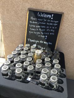 there are many jars with wheels on them and a sign that says, welcome here