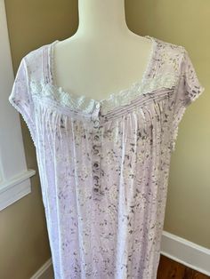 Vintage early 2000's  Eileen West Cotton/Modal Stretch Nightdress with tucks, lace, and appliqué at bodice. Nightie is 60% cotton/40% modal, stretchy 't shirt' type fabric, very soft. Shell buttons at front, cap sleeves, simple easy wear design. Lavender background with small flowers and vines. Knee to ballet length for most.  Relaxed fit.  Labeled Size XL. Check measurements below for accurate fit.  Shoulder to shoulder 16". Bust 54". Arm openings 20" diameter. Length from shoulder to hem about 40". Nightgown in preowned, lightly worn condition. No tears or stains noted. Please see all photos of this Eileen West Nightgown  for complete description. Note computer monitors may vary in display of color. Please convo with questions or for additional photos.  This shop does not  accept returns Purple Lace Sleepwear With Lace Trim, Lavender Lace Trim Sleepwear, Purple Lace Trim Nightgown For Bedtime, Purple Lace Trim Nightgown For Sleep, Purple Lace Trim Nightgown, Lavender Background, Eileen West, Night Dresses, Night Dress For Women