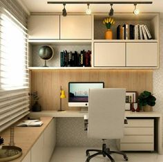 a computer desk with a monitor and keyboard on top of it in front of a bookshelf