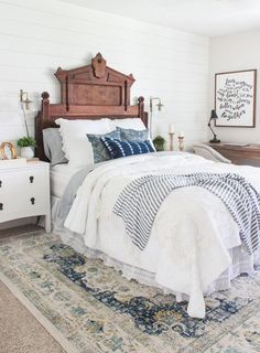 two beds in a room with white walls and wooden headboards on either side of the bed