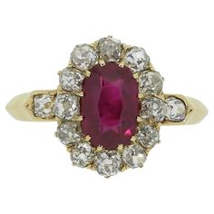 Here we have a fabulous ruby and diamond cluster ring. This antique piece has been crafted from a warm 18ct yellow gold and features an oval faceted rich vivid red ruby of Burmese origin. This outstanding principal stone sits slightly risen in a 12 clawed setting whilst being framed around the outer edge by a circulating array of chunky old mine cut diamonds. A single perfectly matched diamond can be found at either shoulder before the piece is made complete by a neat knife edge band. Condition: Used (Very Good) Weight: 3.2 grams Ring Size: M 1/2 (53) Band Width: 2mm - 1mm Face Dimensions: 13.5mm x 11mm Ruby Weight: Approx. 1.07ct Ruby Details: Origin: Burma, Treatment: None Grading Laboratory: SSEF Total Diamond Weight: Approx. 0.65ct Diamond Details: Approx Colour: H-J, Clarity: VS-SI Ma Antique Ruby Ring, Face Dimensions, Pearl Cluster Ring, Burmese Ruby, Gold Cocktail, Pearl Cluster, Ruby Stone, French Antique, Diamond Cluster Ring