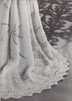 a white crocheted shawl is shown in black and white