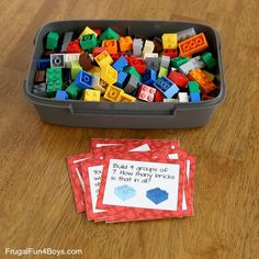 some legos are in a plastic container on the table