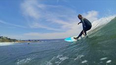 a man riding a wave on top of a surfboard