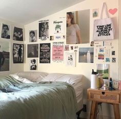 a bedroom with posters on the wall and a bed