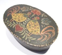 an ornately decorated wooden box on a white surface with flowers and birds painted on it